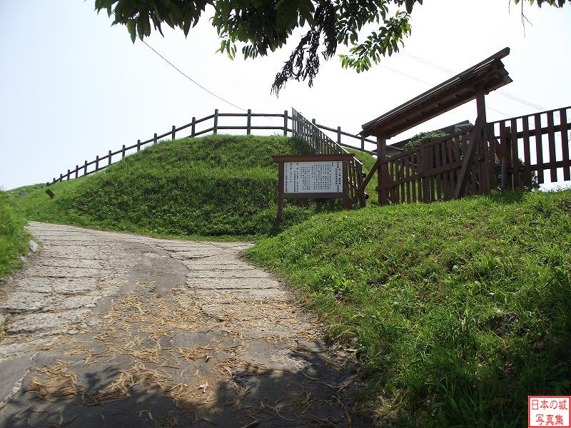 志苔館 館の入口 館の入口の様子。正面は二重空堀の手前土塁、右には慰霊碑がある。