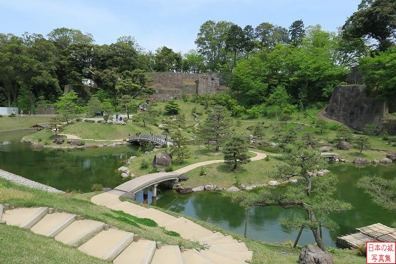 金沢城 玉泉院丸庭園 玉泉院丸庭園の全景。池に大中小３つの島がうかび、橋で結ばれている。芝生と松の緑が鮮やか。庭園の向こうには美しい石組みが見える。水は辰巳用水から引いてきていた。